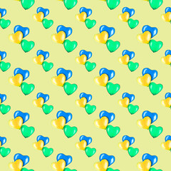 On a yellow background, blue, green and yellow hearts. Watercolor seamless pattern for textiles, design, decor, pillows, packaging paper, postcards.