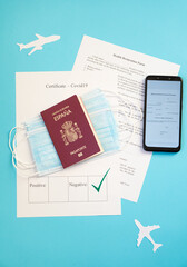 Passport with certificate of immunity covid19, smartphone that shows negative pcr test, covidfree, ready to travel with surgical masks, new normal, travel safely, protocols, with blue backg