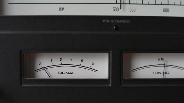 Turning retro radio by hand. Band tuning of old classic radio receiver. Close up