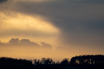 Evening light and dramatic clouds at sunset in winter
