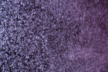 Abstract festive background with selective focus. Bright white particles on dark background....