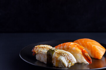 Japanese seafood on dark background. Sushi Set.