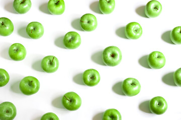 Green apples rows on white background. Fruit pattern background. Top view.