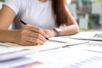 Close up of hand taking a notes.