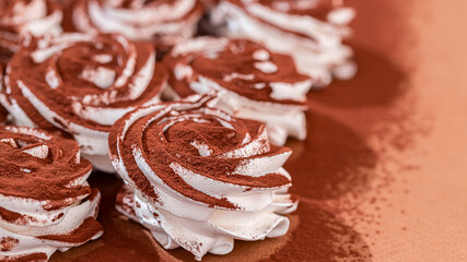 Delicate zephyr sprinkled with cocoa powder. Low-calorie marshmallows. Homemade dessert.