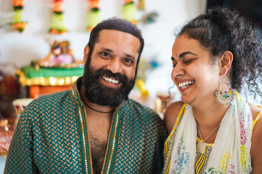 Indian husband and wife smiling in front of the camera - Focus on woman face