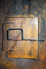 rusty iron door of a coal furnace