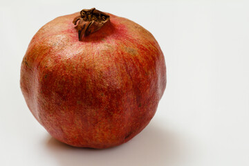 Fototapeta na wymiar Pomegranate on the white background. Top view.