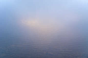 Beautiful landscape image of misty Derwentwater in Lake District on cold Winter morning
