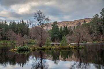 Stunning landscape image of Glencoe Lochan with Pap of Glencoe in the distance on a Winter's evening