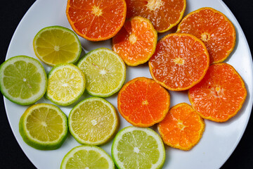 Fototapeta na wymiar citrus fruit cut on a white plate