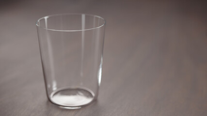 tumbler glass on walnut table with copy space