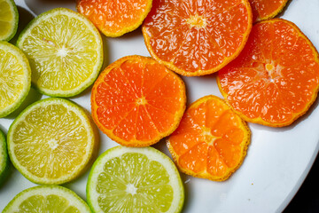 Fototapeta na wymiar citrus fruit cut on a white plate