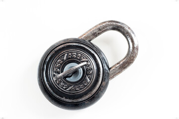 Obraz premium Corroded Old vintage lock with beautiful metalwork decoration isolated on white with key inside hole