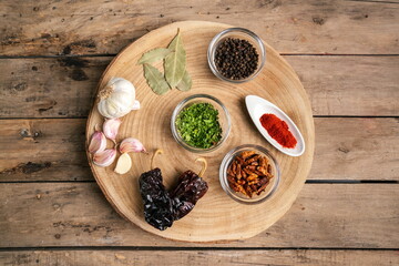Various spices in glass bowl on wooden table