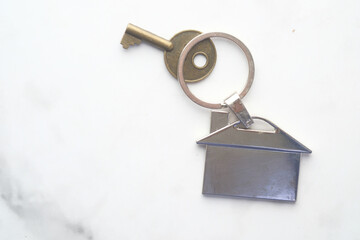 home finance concept with key and house symbol on white 