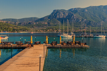 Wooden Pier leading to sailing boats in the bay of Akbuk Limani, Gokova, Turkey