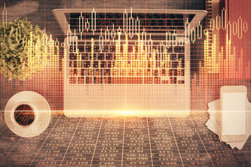Stock market chart and top view computer on the table background. Double exposure. Concept of financial analysis.