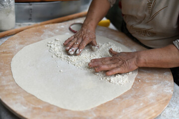 Turkish Food. Gozleme (Turkish stuffed flatbread) cooking process in traditional style. Adding cheese feta