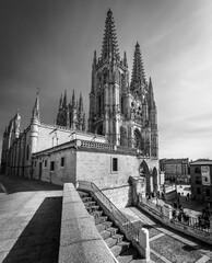 Gothic Cathedral of Burgos by day and with clear blue sky. Wide-angle photo. Monochrome, Black and white.
