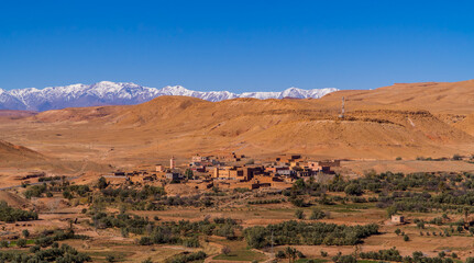 Berber villages near Ait Benhaddou, Morocco with snow-capped mountains of the Atlas in the background