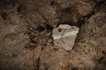 Watching the beach through a hole in the cliff