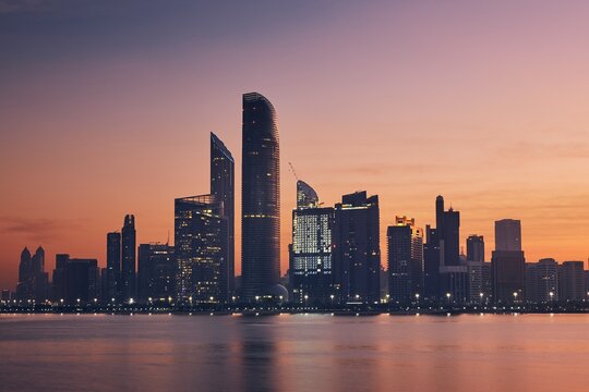 Urban skyline with skyscrapers at beautiful dawn. Cityscape Abu Dhabi, United Arab Emirates. 