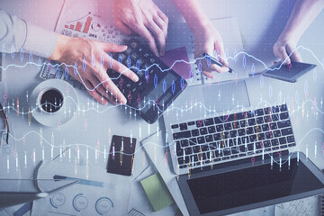 Double exposure of man and woman working together and financial chart hologram drawing. market...