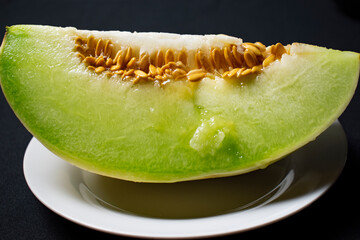 fresh melon cut on a white plate