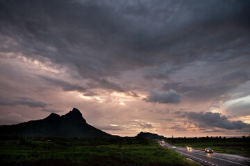 Naklejka premium Sunset sky and mountain silhouette in Mauritius.