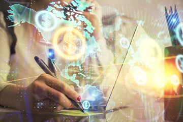 Double exposure of woman hands typing on computer and financial graph hologram drawing. Stock market analysis concept.