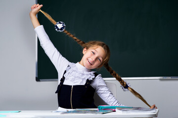 Schoolgirl holding her braids.Back to school, education concept.