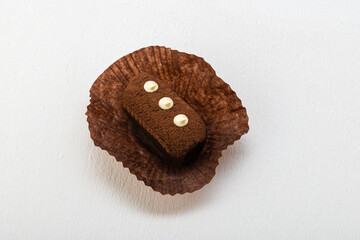 Potato cake, with cream buttons on paper on a light background