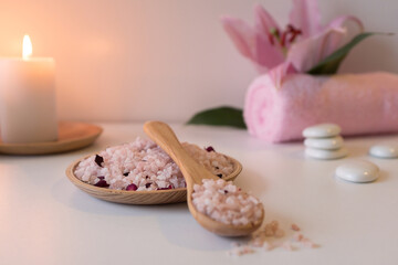 Rose sea salt, candles, towels and lily flower