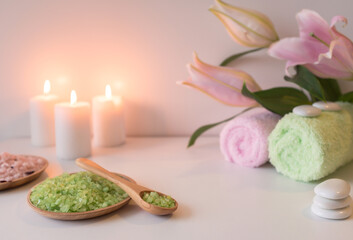 Green sea salt with towels, candles  and lily flower