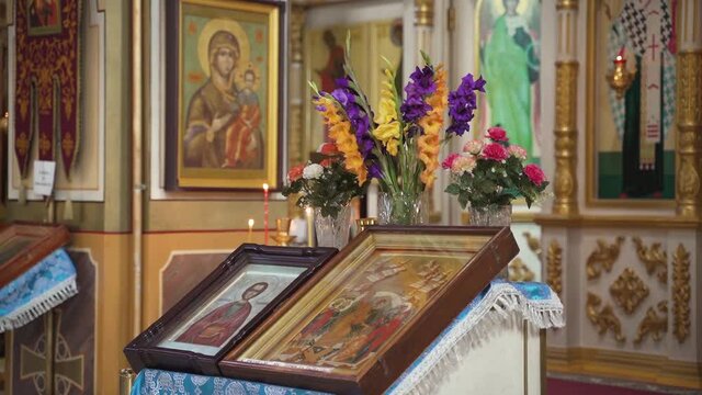 Icons and flowers inside the church. Altar in an Orthodox church