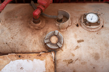 Diesel fuel storage tank of the engine motor device. Close-up and selective focus at the cap 's part, industrial object photo.