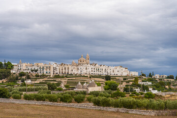 View of the skyline of Locortondo in Puglia from an olive tree field