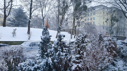 Winter in the city. Snow-covered streets and snow-covered cars.