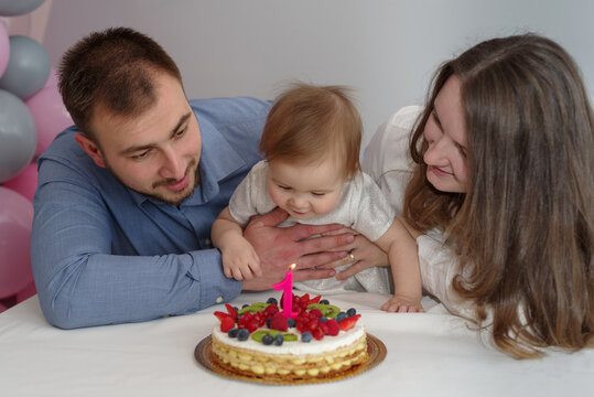 Parents and baby celebrating first birthday