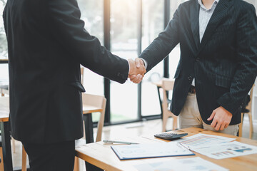 Businessman shaking hands at the end of the meeting at the office.