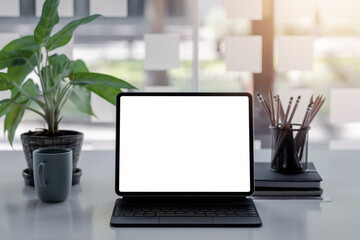 Fototapeta premium Digital tablet with blank screen on table in office. Mock up.