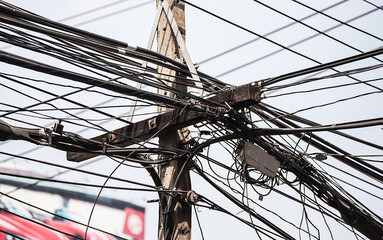 Intertwining of many electrical wires on poles