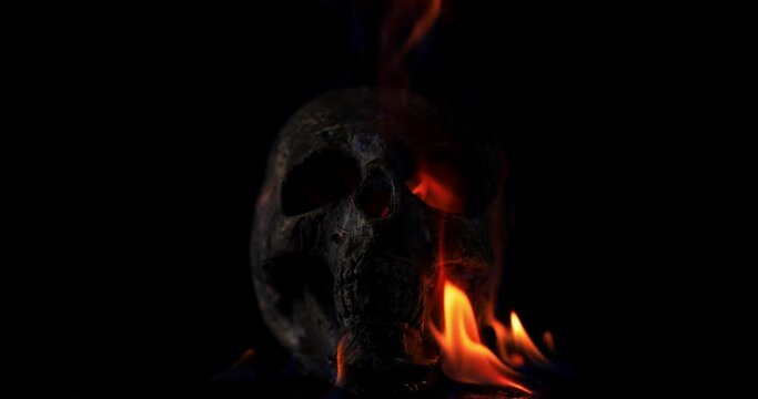 Burning skull in the darkness