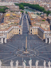 Famous Egyptian obelisk in the center of St. Peters Square, Via della Conciliazione, Sant'Angelo castle and cityscape of Rome in the background. View from above. Italy.