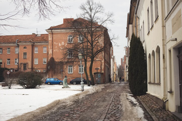 Klaipeda, Lithuania - January 24 2021. A gloomy grey weather, dirty melted snow in Klaipeda old town. No people on streets, everything is closed due to Covid-19 lockdown