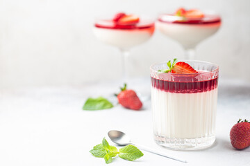 Italian panna cotta dessert with strawberry sirup and mint leaf