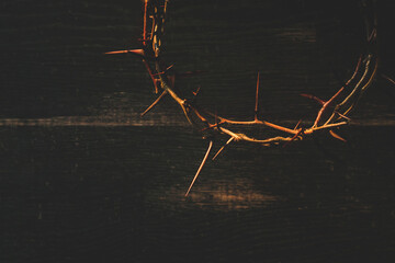 Crown of thorns on wooden table, closeup with space for text. Easter attribute - 409470451