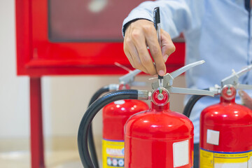 Expert engineers inspect fire extinguishers to be ready for use.