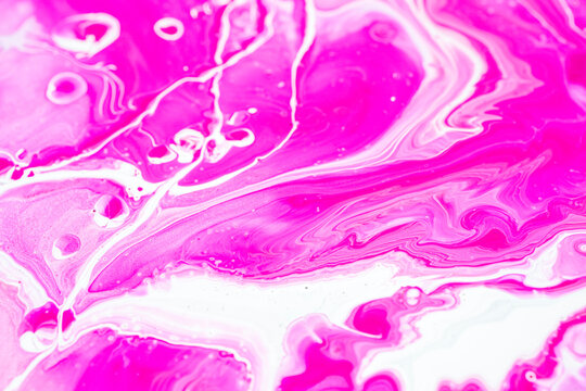 Fluid art texture. Closeup abstract pink, white and grey colors mixing of acrylic for use as background. Liquid acrylic artwork that flows and splashes with marble pattern